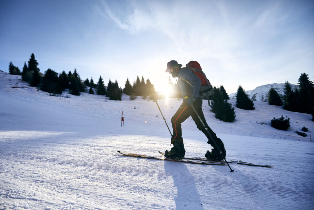 uphill-traveler-on-backcountry-skis-inside-ski-resort-boundaries