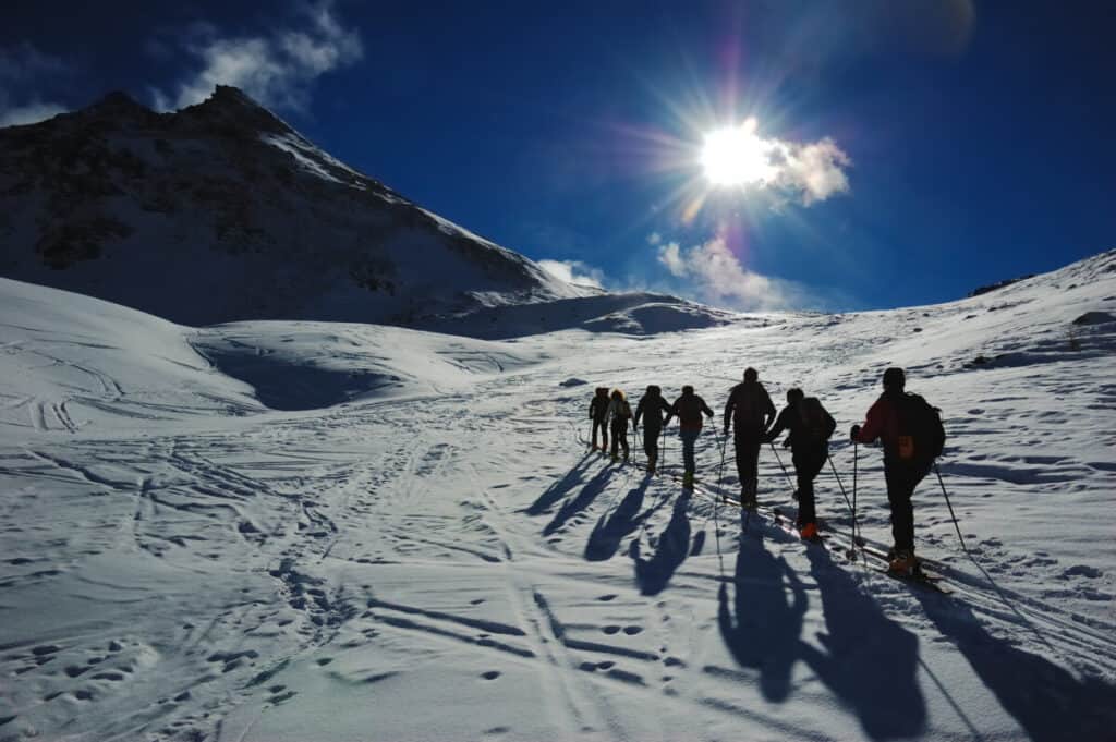 backcountry-skiers-climbing-single-file