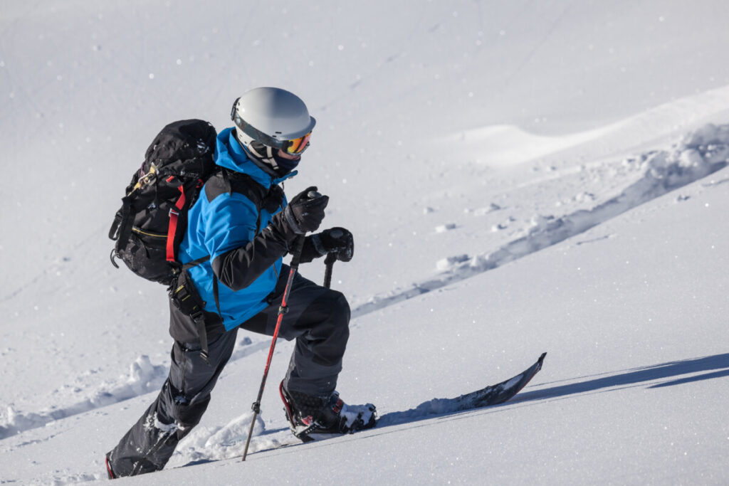 skier-alpine-touring-up-steep-pow-covered-slope
